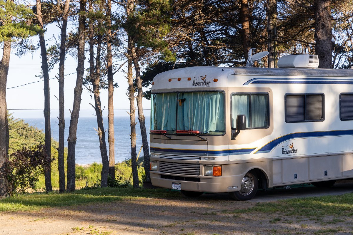 An RV at its site with sea stacks and the Pacific beyond at Honey Bear By The Sea