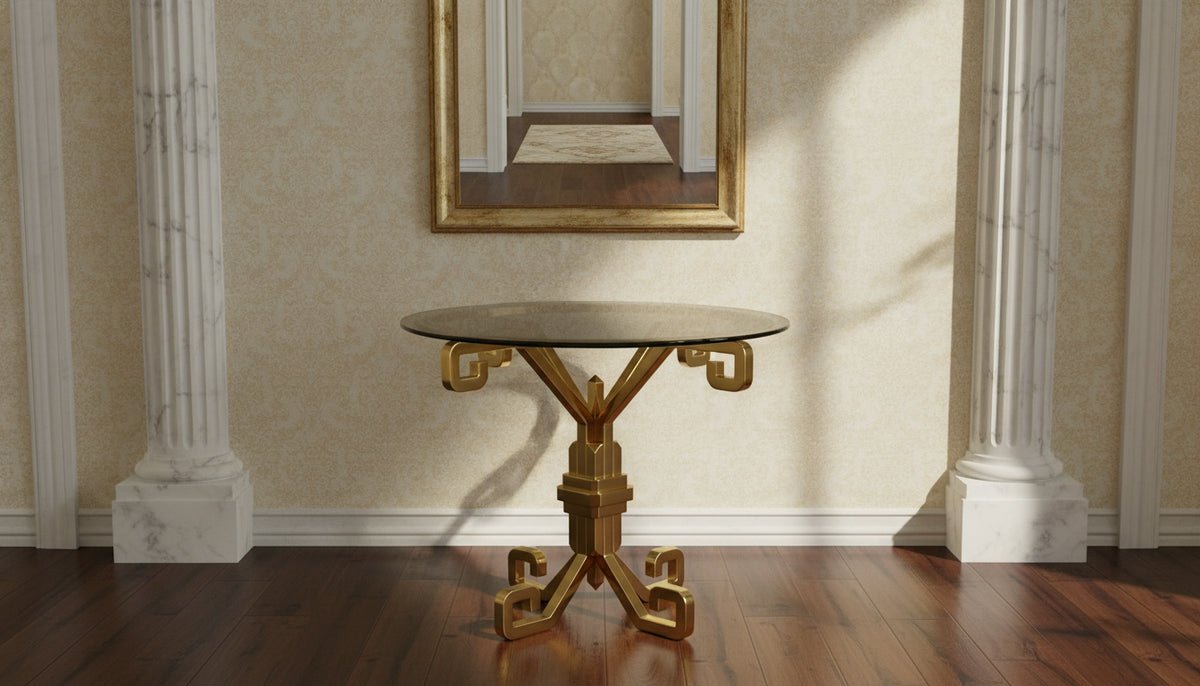 A gold framed wall mirror above a gold entrance table between white columns